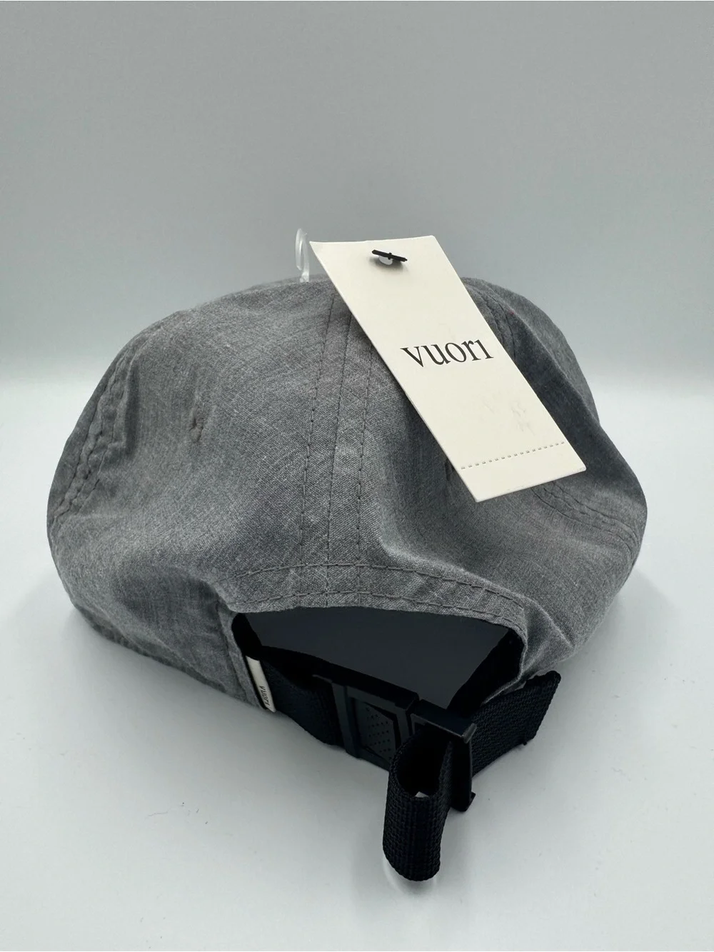 Vuori Gray Five-Panel Adjustable Cap/ Front Patch with faint camo design on brim